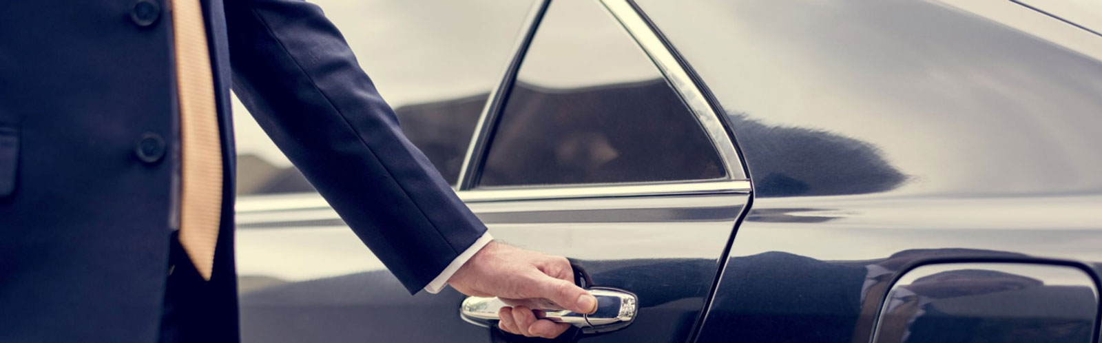 chauffeur about to open the limousine door